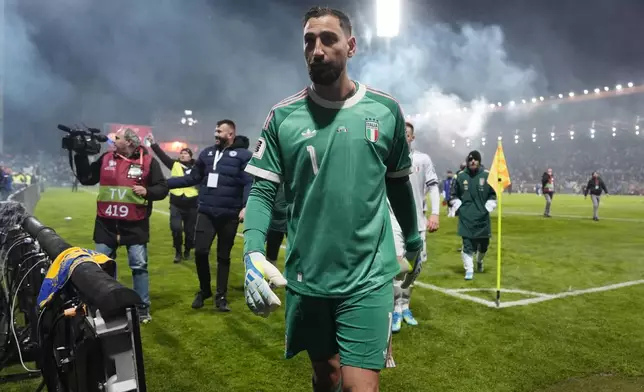 Italy's Gianluigi Donnarumma walks off the pitch after losing in a World Cup qualifying playoff final soccer match between Bosnia and Italy in Zenica, Bosnia, Tuesday, March 31, 2026. (Fabio Ferrari/LaPresse via AP)