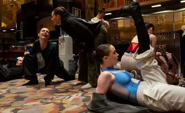 Dancers warm up and stretch before an audition for the Radio City Rockettes at Radio City Music Hall in New York, on Wednesday, April 22, 2026. (AP Photo/Yuki Iwamura)