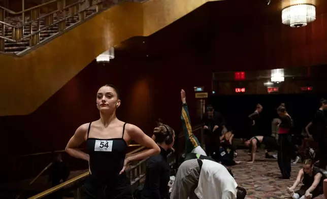 Dancers warm up and stretch before an audition for the Radio City Rockettes at Radio City Music Hall in New York, on Wednesday, April 22, 2026. (AP Photo/Yuki Iwamura)