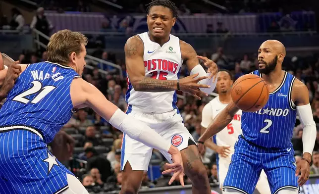 Detroit Pistons guard Marcus Sasser, center, loses control of the ball as he is defended by Orlando Magic forward Moritz Wagner (21) and guard Jevon Carter (2) during the first half of an NBA basketball game, Monday, April 6, 2026, in Orlando, Fla. (AP Photo/John Raoux)