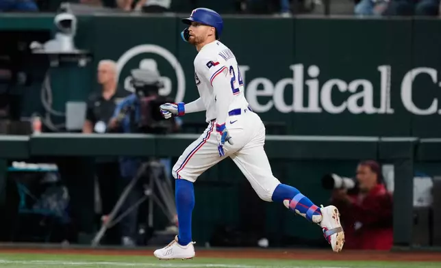 Texas Rangers' Brandon Nimmo sprints out of the batters box watching his fly out to center in the second inning of a baseball game against the New York Yankees Wednesday, April 29, 2026, in Arlington, Texas. (AP Photo/Tony Gutierrez)