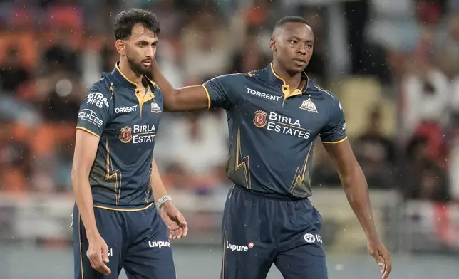 Gujarat Titans' Prasidh Krishna celebrates with Kagiso Rabada the wicket of Punjab Kings' Shashank Singh during the Indian Premier League cricket match between Gujarat Titans and Punjab Kings in New Chandigarh, India, Tuesday, March 31, 2026. (AP Photo/Ashwini Bhatia)