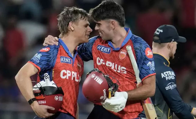 Punjab Kings' Cooper Connolly, left, and Xavier Bartlett celebrates the win against Gujarat Titans during the Indian Premier League cricket match in New Chandigarh, India, Tuesday, March 31, 2026. (AP Photo/Ashwini Bhatia)