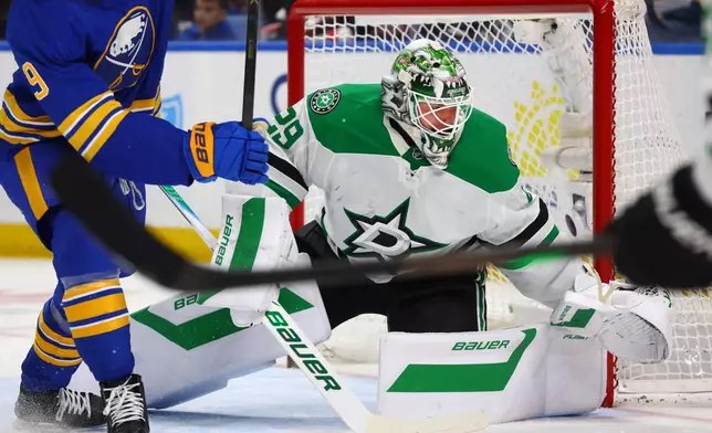 Dallas Stars goaltender Jake Oettinger (29) watches the puck during the first period of an NHL hockey game against the Buffalo Sabres Wednesday, April 15, 2026, in Buffalo, N.Y. (AP Photo/Jeffrey T. Barnes)