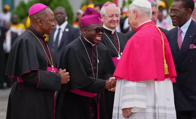 Pope Leo XIV, flanked by Equatorial Guinea's President Teodoro Obiang Nguema Mbasogo, right, is welcomed by Archbishop Juan Nsue Edjang Mayé, left, and Juan Domingo-Beka Esono Ayang upon his arrival at Malabo International Airport in Malabo, Equatorial Guinea, Tuesday, April 21, 2026. (AP Photo/Misper Apawu)
