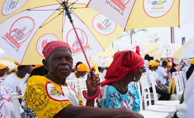 Faithful wait for the arrival of Pope Leo XIV on the occasion of his meeting with representatives of the world of culture in Malabo, Equatorial Guinea, Tuesday, April 21, 2026, on the ninth day of his 11-day pastoral visit to Africa. (AP Photo/Misper Apawu)