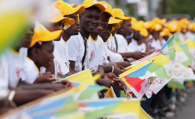 Faithful wait for the arrival of Pope Leo XIV at the airport in Malabo, Equatorial Guinea, Tuesday, April 21, 2026. (AP Photo/Misper Apawu)