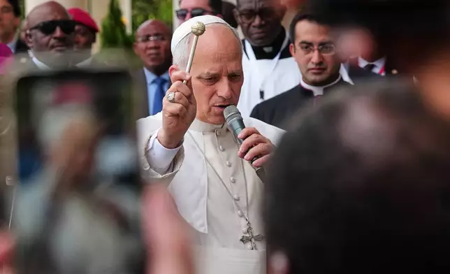 Pope Leo XIV blesses the faithful at the Basilica of the Immaculate Conception in Mongomo, Equatorial Guinea, Wednesday, April 22, 2026. (AP Photo/Misper Apawu)