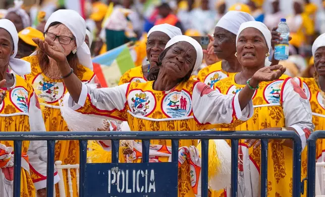 Faithful wait for the arrival of Pope Leo XIV at the Basilica of the Immaculate Conception, on the 10th day of his 11-day pastoral visit to Africa, in Mongomo, Equatorial Guinea, Wednesday, April 22, 2026. (AP Photo/Misper Apawu)