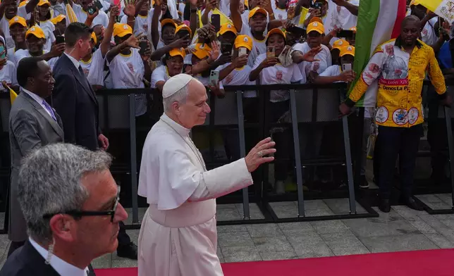 Pope Leo XIV waves to the faithful prior to the start of a meeting with representatives of the world of culture in Malabo, Equatorial Guinea, Tuesday, April 21, 2026, on the ninth day of his 11-day pastoral visit to Africa. (AP Photo/Misper Apawu)