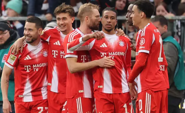 Bayern's Michael Olise, third from right, celebrates with teammates after scoring his side's third goal during the German Bundesliga soccer match between FC St. Pauli and Bayern Munich in Hamburg, Germany, Saturday, April 11, 2026. (Christian Charisius/dpa via AP)