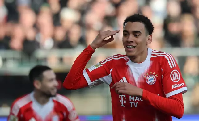 Bayern's Jamal Musiala celebrates after scoring during the German Bundesliga soccer match between FC St. Pauli and Bayern Munich in Hamburg, Germany, Saturday, April 11, 2026. (Christian Charisius/dpa via AP)