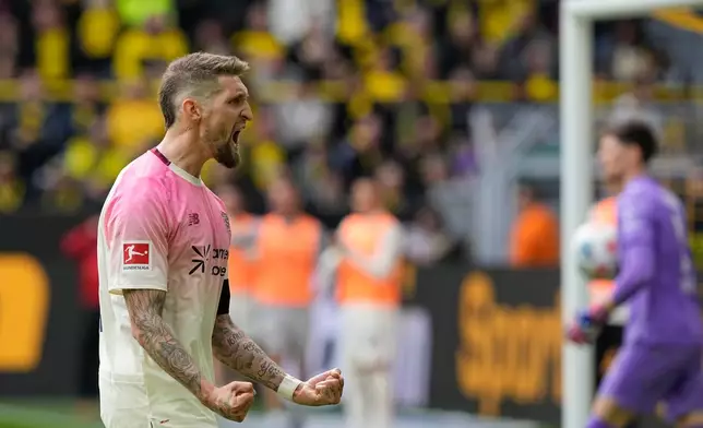 Leverkusen's Robert Andrich celebrates after scoring during the German Bundesliga soccer match between Borussia Dortmund and Bayer Leverkusen in Dortmund, Germany, Saturday, April 11, 2026. (AP Photo/Martin Meissner)