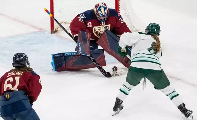 Montreal Victoire goaltender Ann-Renee Desbiens, top, makes a save against Boston Fleet's Haley Winn (8) during third-period PWHL hockey game action in Laval, Quebec, Friday, April 17, 2026. (Christopher Katsarov/The Canadian Press via AP)