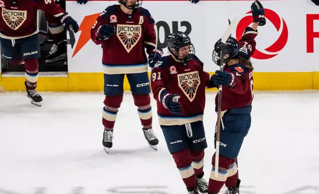 Montreal Victoire's Nicole Gosling, right, celebrates after her winning goal with teammate Maggie Flaherty (91) during overtime PWHL hockey game action against the Boston Fleet in Laval, Quebec, Friday, April 17, 2026. (Christopher Katsarov/The Canadian Press via AP)
