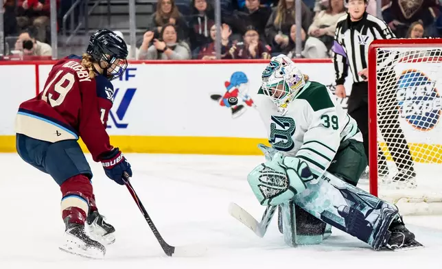 Boston Fleet goaltender Abbey Levy (39) makes a save against Montreal Victoire's Kaitlin Willoughby (19) during second-period PWHL hockey game action in Laval, Quebec, Friday, April 17, 2026. (Christopher Katsarov/The Canadian Press via AP)