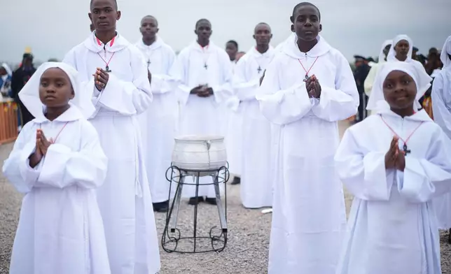 Faithful wait for Pope Leo XIV at Yaounde Ville Airport, Cameroon, Saturday, April 18, 2026 on the sifth day of his 11-day pastoral visit to Africa. (AP Photo/Andrew Medichini)