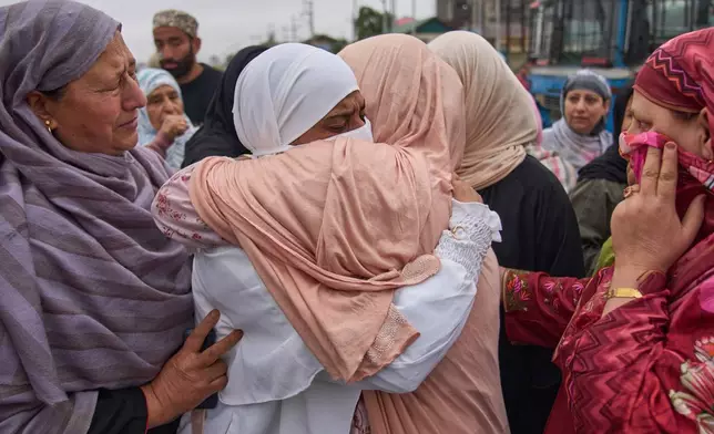 A Kashmiri Muslim pilgrim, in white, is given a farewell hug by her relative as she leaves for the annual hajj pilgrimage to the holy city of Mecca, in Srinagar, Indian-controlled Kashmir, Saturday, April 18, 2026. (AP Photo/Dar Yasin)