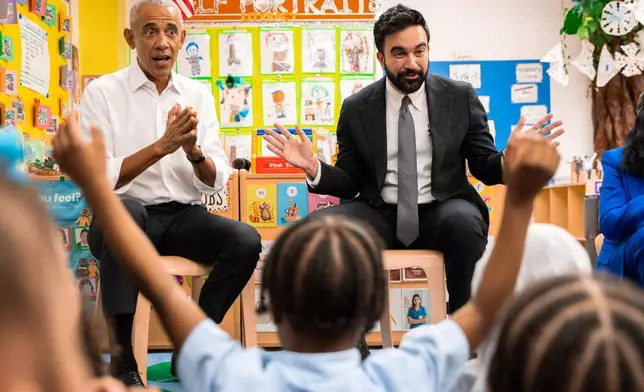 Former President Barack Obama and Mayor Zohran Mamdani sing "Wheels on the Bus" to children at Learning Through Play Pre-K in the Bronx in New York, Saturday, April 18, 2026. (AP Photo/Angelina Katsanis)
