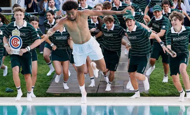 France's Arthur Fils jumps in the pool after his victory against Russia's Andrey Rublev in the ATP Barcelona Open tennis final in Barcelona, Spain, Sunday, April 19, 2026. (AP Photo/Joan Monfort)