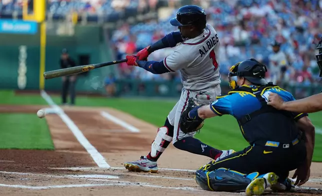 Atlanta Braves' Ozzie Albies hits a one-run single off of Philadelphia Phillies pitcher Taijuan Walker during the first inning of a baseball game, Friday, April 17, 2026, in Philadelphia. (AP Photo/Matt Rourke)