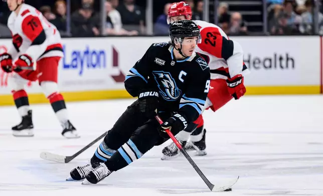 Utah Mammoth right wing Clayton Keller (9) skates with the puck during the third period of an NHL hockey game against the Carolina Hurricanes, Saturday, April 11, 2026, in Salt Lake City. (AP Photo/Tyler Tate)
