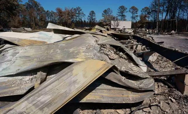 The burned out remains of the Wedding Chapel at covenant acres is seen near the Brantley Highway 82 fire, Thursday, April 23, 2026, near Nahunta, Ga. (AP Photo/Mike Stewart)