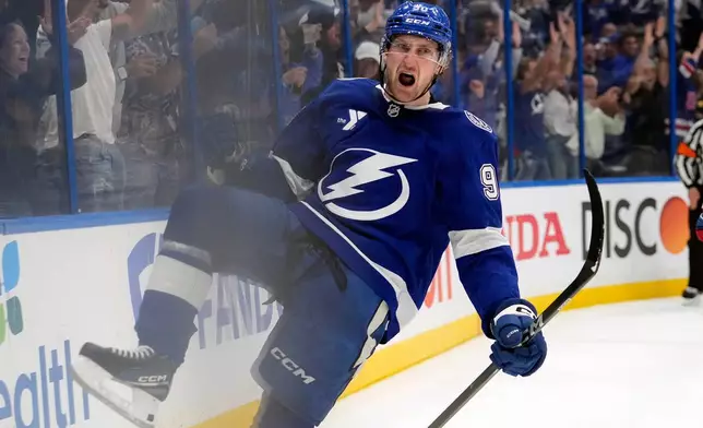 Tampa Bay Lightning defenseman J.J. Moser (90) celebrates after scoring the game-winning goal against the Montréal Canadiens during overtime in Game 2 of an NHL hockey Stanley Cup first-round playoff series, Tuesday, April 21, 2026, in Tampa, Fla. (AP Photo/Chris O'Meara)