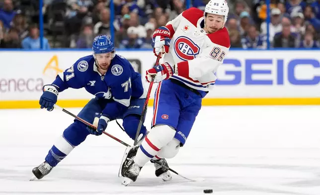 Montréal Canadiens left wing Alexandre Texier (85) gets tripped up by Tampa Bay Lightning center Anthony Cirelli (71) during the first period in Game 2 of an NHL hockey Stanley Cup first-round playoff series, Tuesday, April 21, 2026, in Tampa, Fla. (AP Photo/Chris O'Meara)