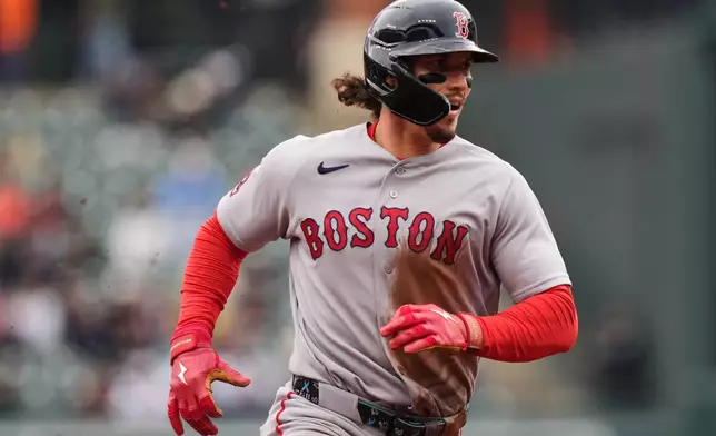 Boston Red Sox's Jarren Duran advances to third base on a wild pitch by Baltimore Orioles starting pitcher Kyle Bradish during the third inning of a baseball game, Sunday, April 26, 2026, in Baltimore. (AP Photo/Stephanie Scarbrough)