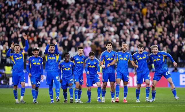 Leeds United's Dominic Calvert-Lewin, third right, and teammates celebrate in the penalty shoot-out during the English FA Cup quarterfinal soccer match between West Ham United and Leeds United, in London, Sunday April 5, 2026. (John Walton/PA via AP)