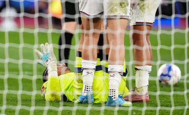 West Ham United goalkeeper Alphonse Areola goes down injured before being replaced by substitute goalkeeper Finlay Herrick in extra-time during the English FA Cup quarterfinal soccer match between West Ham United and Leeds United, in London, Sunday April 5, 2026. (John Walton/PA via AP)