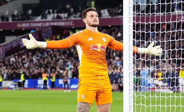 Leeds United goalkeeper Lucas Perri celebrates saving West Ham United's Jarrod Bowen penalty in the shoot-out during the English FA Cup quarterfinal soccer match between West Ham United and Leeds United, in London, Sunday April 5, 2026. (John Walton/PA via AP)