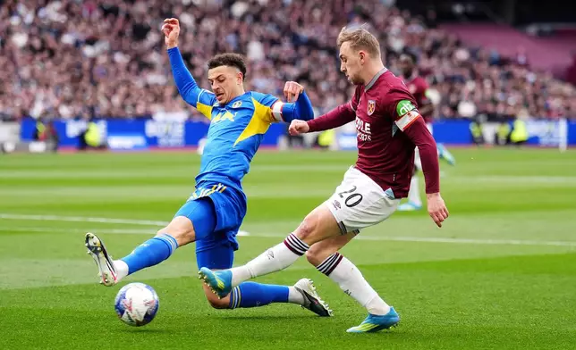 West Ham United's Jarrod Bowen, right, and Leeds United's Ethan Ampadu in action during the English FA Cup quarterfinal soccer match between West Ham United and Leeds United in London, Sunday April 5, 2026. (John Walton/PA via AP)