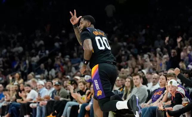 Phoenix Suns forward Royce O'Neale celebrates his 3-pointer against the Dallas Mavericks during the first half of an NBA basketball game, Wednesday, April 8, 2026, in Phoenix. (AP Photo/Ross D. Franklin)