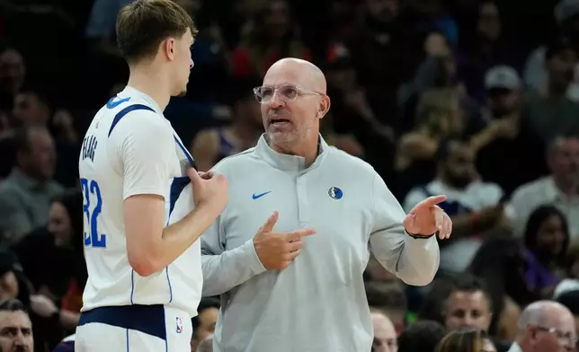 Dallas Mavericks head coach Jason Kidd, right, talks with Mavericks forward Cooper Flagg (32) during the first half of an NBA basketball game against the Phoenix Suns, Wednesday, April 8, 2026, in Phoenix. (AP Photo/Ross D. Franklin)