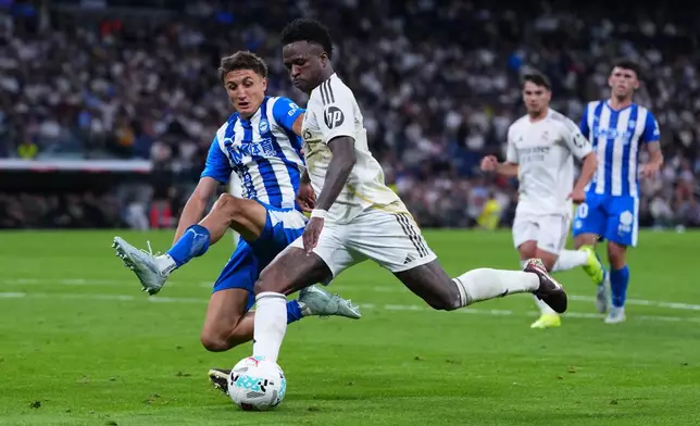 FILE - Alaves' Nahuel Tenaglia tries to block Real Madrid's Vinicius Junior during a La Liga soccer match between Real Madrid and Alaves in Madrid, Spain, Tuesday, April 21, 2026. (AP Photo/Manu Fernandez, File)