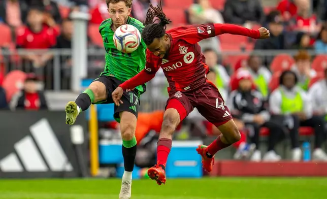 Toronto FC's Raheem Edwards (44) and Austin FC's Jon Gallagher (17) battle for the ball during the first half of an MLS soccer game in Toronto, Saturday, April 18, 2026. (Frank Gunn/The Canadian Press via AP)