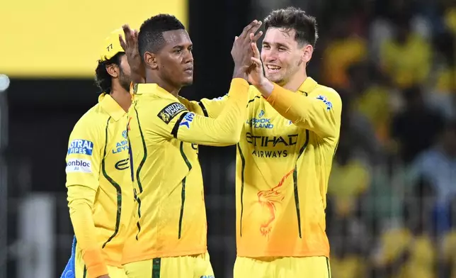 Chennai Super Kings' Akeal Hosein, center, celebrates with teammates the wicket of Kolkata Knight Riders' Angkrish Raghuvanshi during the Indian Premier League cricket match between Chennai Super Kings and Kolkata Knight Riders in Chennai, India, Tuesday, April 14, 2026. (AP Photo)