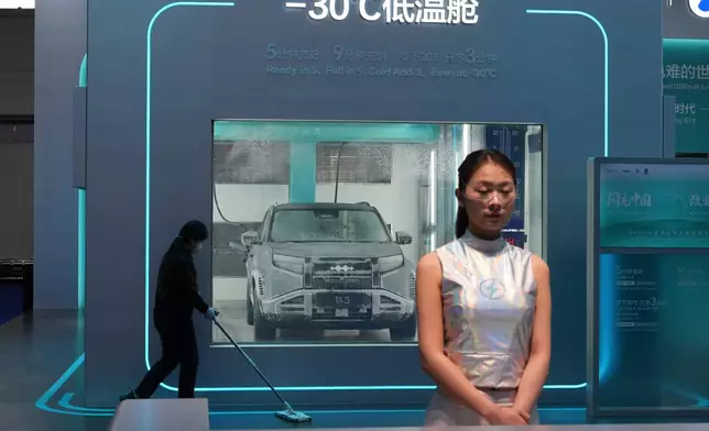 A cleaner past by a chamber with sub-zero temperatures to showcase the battery charging technologies at the BYD booth during Auto China 2026 in Beijing, Friday, April 24, 2026. (AP Photo/Ng Han Guan)