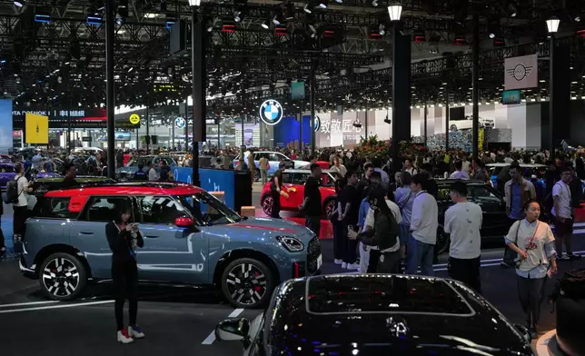 Visitors tour the Auto China 2026, in Beijing, Friday, April 24, 2026. (AP Photo/Andy Wong)