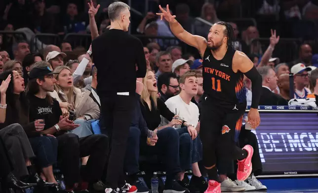 New York Knicks guard Jalen Brunson (11) gestures after scoring a three point basket during the first half of an NBA basketball game against the Chicago Bulls, Friday, April 3, 2026, in New York. (AP Photo/Heather Khalifa)