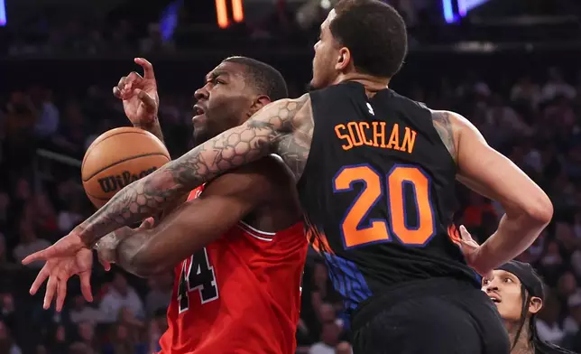 Chicago Bulls forward Patrick Williams (44) drives to the basket past New York Knicks forward Jeremy Sochan (20) during the first half of an NBA basketball game, Friday, April 3, 2026, in New York. (AP Photo/Heather Khalifa)