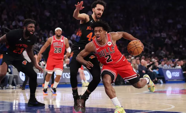 Chicago Bulls guard Collin Sexton (2) drives to the basket past New York Knicks guard Landry Shamet during the first half of an NBA basketball game, Friday, April 3, 2026, in New York. (AP Photo/Heather Khalifa)