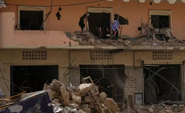 Residents remove rubble from their destroyed house on the second day of a ceasefire between Hezbollah and Israel in Jibchit village, south Lebanon, Saturday, April 18, 2026.(AP Photo/Mohammed Zaatari)