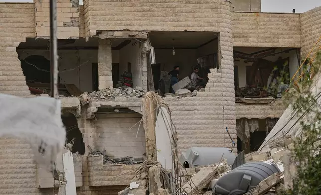 Residents remove rubble from their destroyed house on the second day of a ceasefire between Hezbollah and Israel in Nabatiyeh town, south Lebanon, Saturday, April 18, 2026.(AP Photo/Mohammed Zaatari)