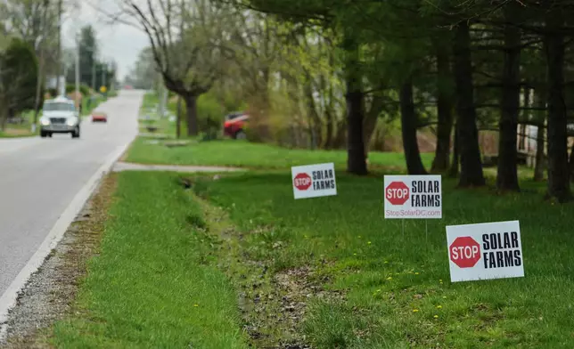 Signs opposing solar development sit near a road Friday, April 3, 2026, in Manchester, Ind. (AP Photo/Joshua A. Bickel)