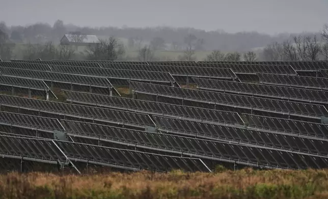 Solar panels operate Wednesday, Jan. 14, 2026, at a farm in Lancaster, Ky. (AP Photo/Joshua A. Bickel)