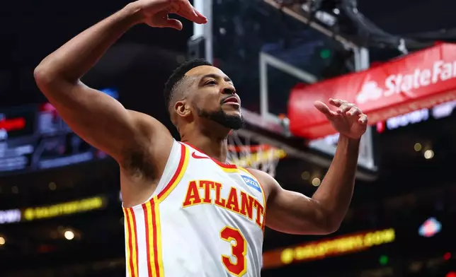 Atlanta Hawks guard CJ McCollum (3) reacts to the crowd during the first half in Game 3 of a first-round NBA playoffs basketball series against the New York Knicks, Thursday, April 23, 2026, in Atlanta. (AP Photo/Colin Hubbard)