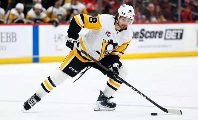 Pittsburgh Penguins center Tommy Novak skates with the puck during the first period of an NHL hockey game against the New Jersey Devils, Thursday, April 9, 2026, in Newark, N.J. (AP Photo/Noah K. Murray)